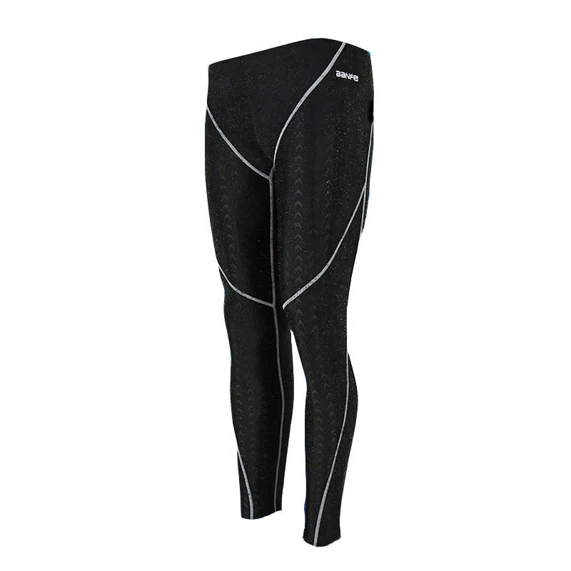 Men's black and green line nylon cropped swimming trunks on a white background.