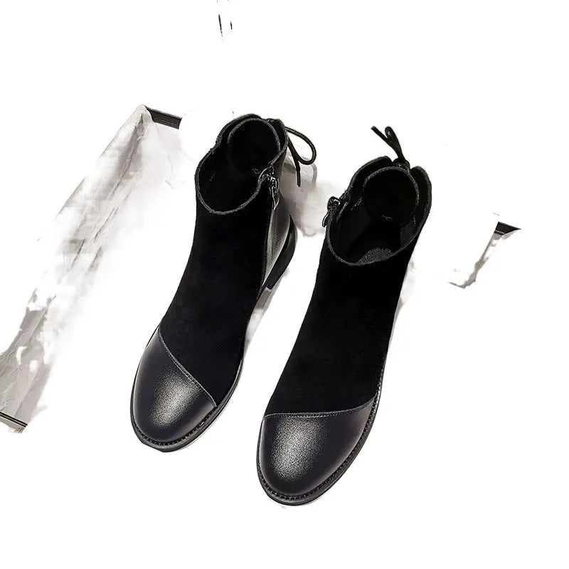 Black women's Martin boots with non-slip rubber soles and side zipper, showing round toe and short stout heel.