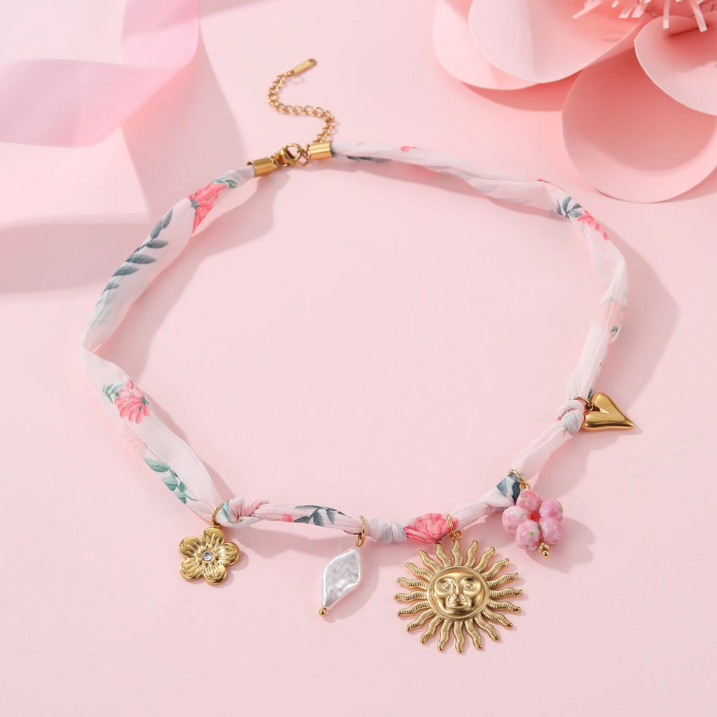 Stainless steel necklace with a geometric sun pendant on a regular chain, showing heart and ribbon sun style options.