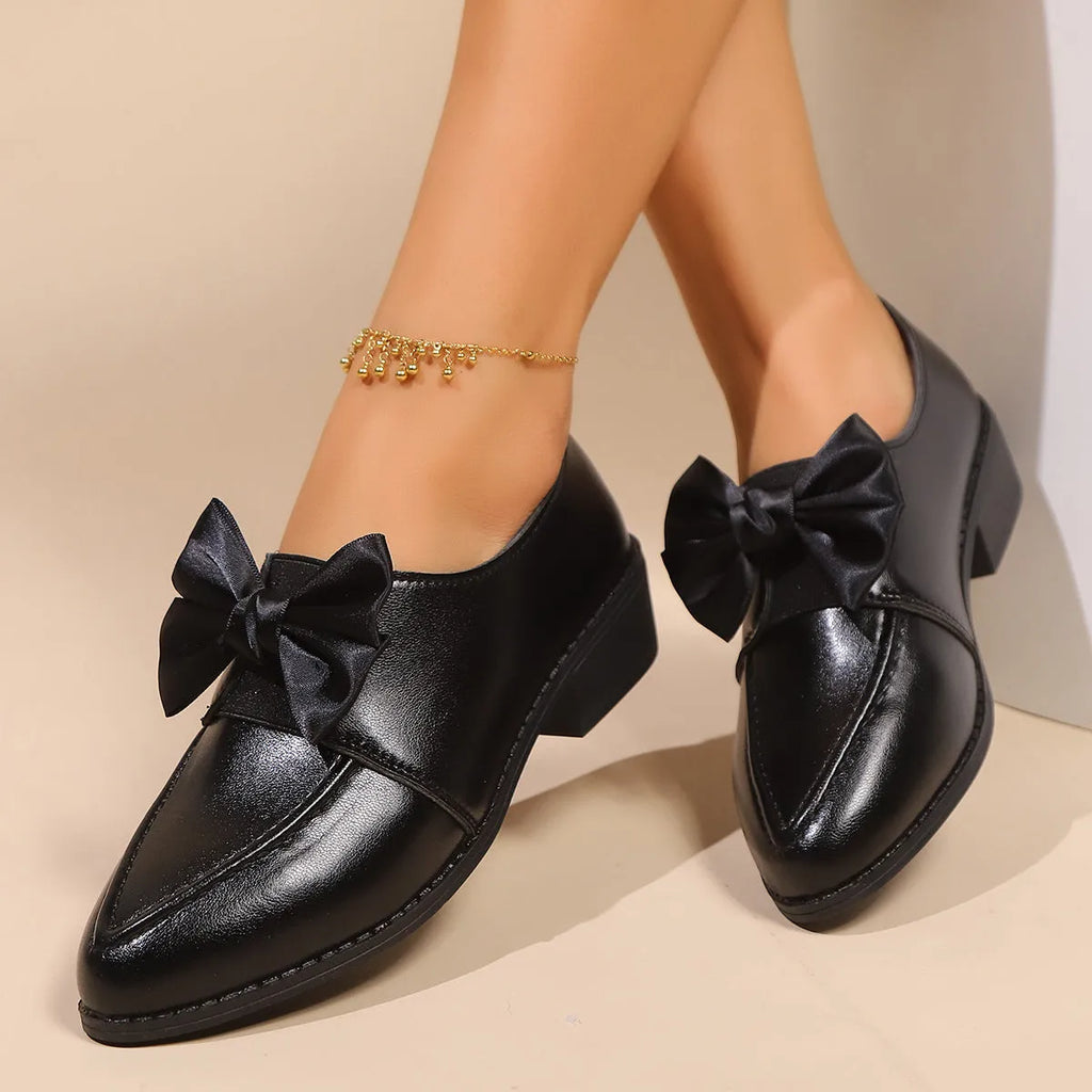 Women's British-style simple leather shoes with bow detailing, PU upper, and rubber sole in available sizes.