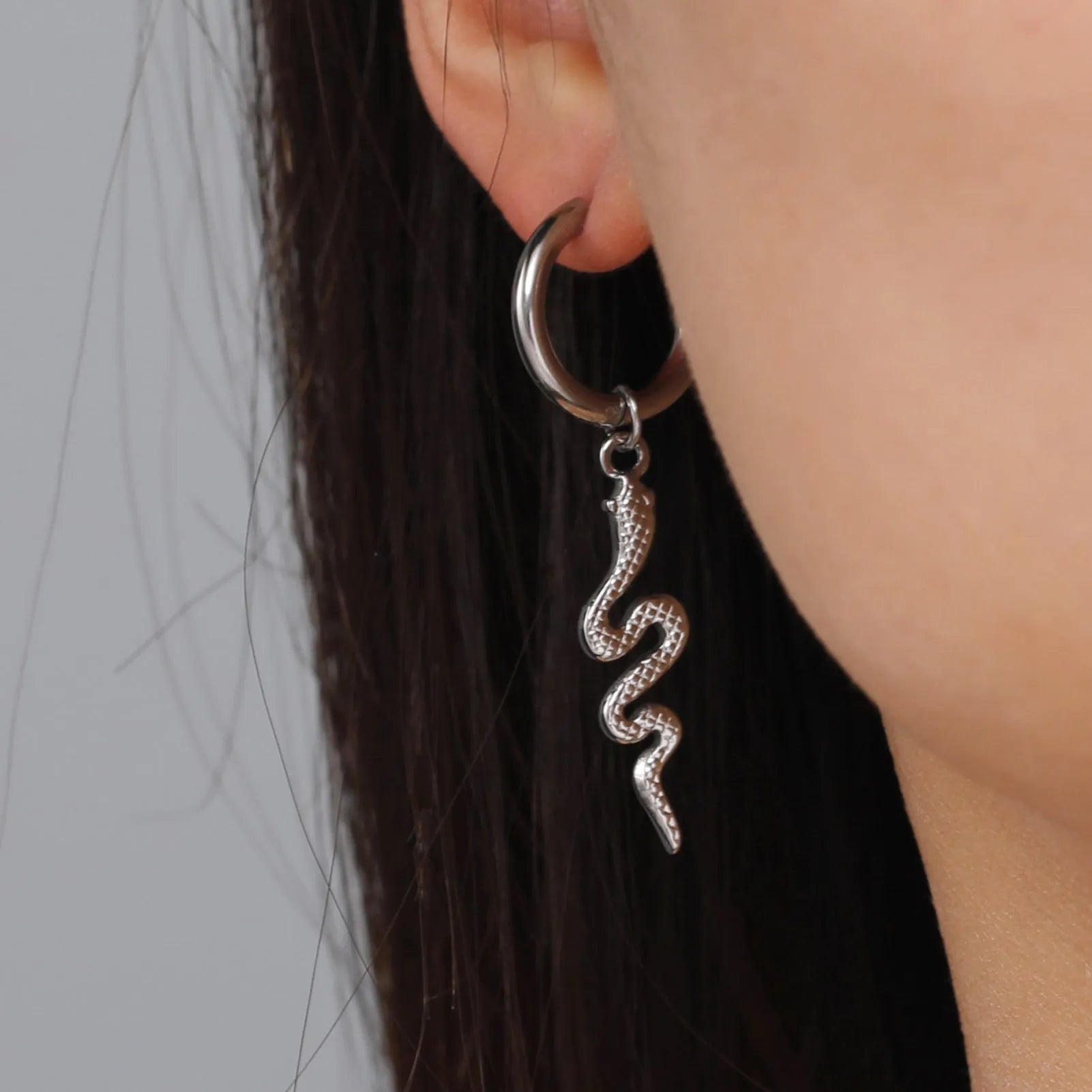 Gold plated stainless steel snake-shaped vintage earrings with detailed scale patterning and clip back closure