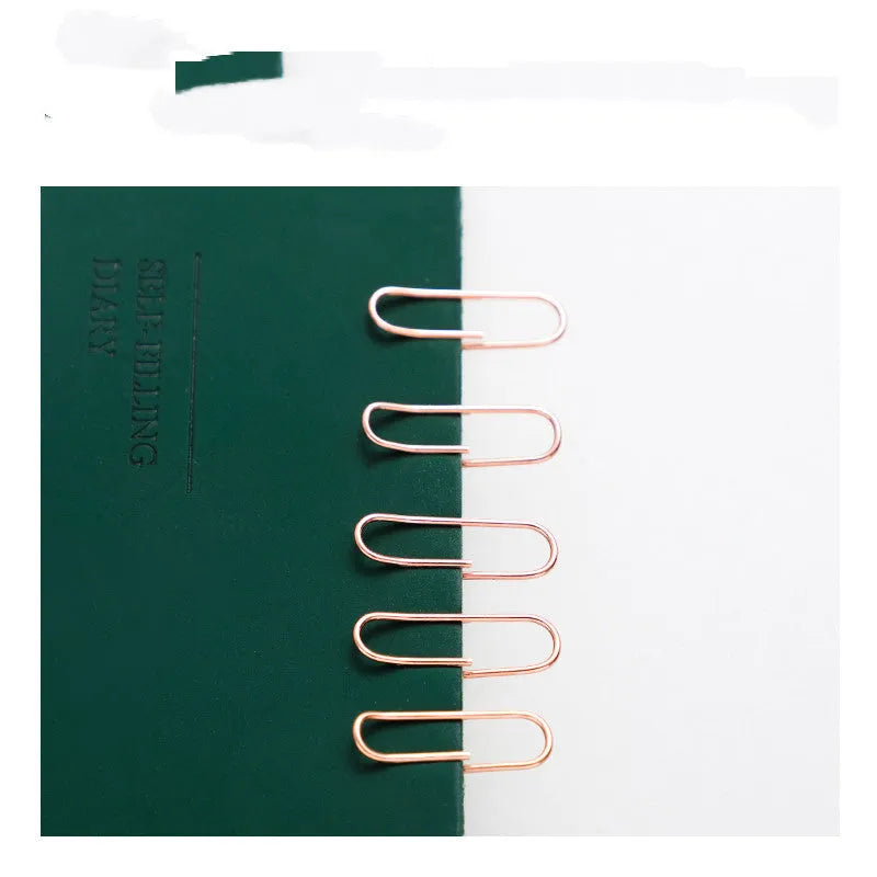 Rose gold coloured heart-shaped metal paper clips, 28mm size, in a box of 100 pieces.