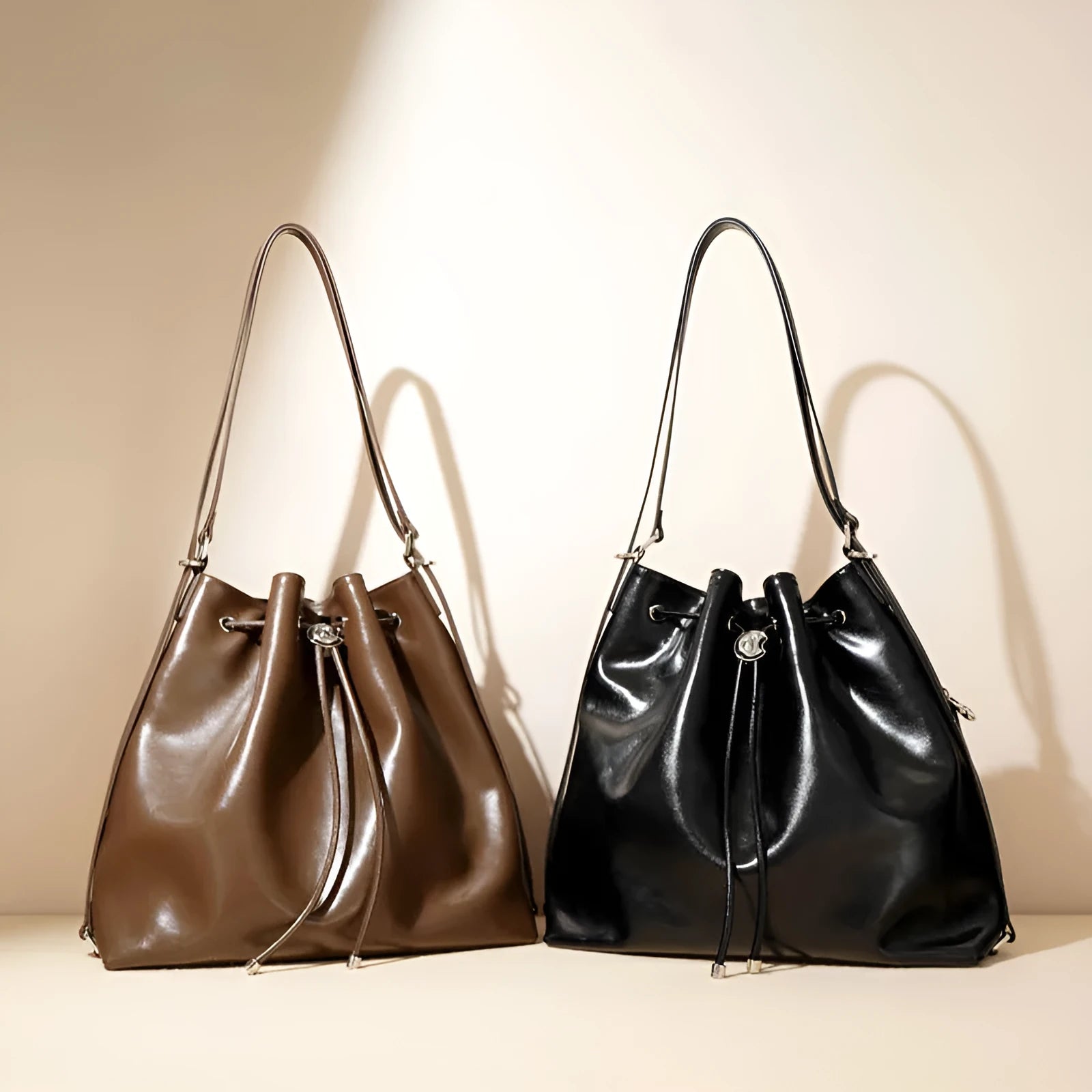 Genuine leather one-shoulder bucket bag in brown showing interior file compartment and zippered pockets