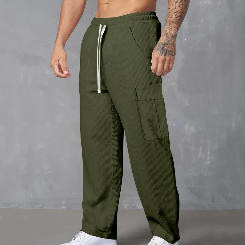 Men's straight-leg corduroy trousers in navy blue with drawstring waist, showing texture detail and relaxed fit