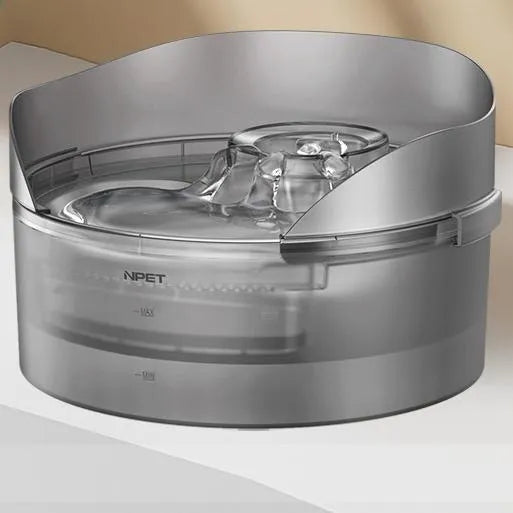 Automatic circulating water dispenser for cats and dogs with filter cartridge on a kitchen floor.