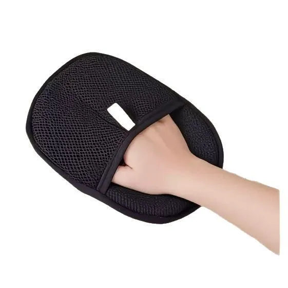 Black pet hair remover glove with soft silicone bristles on a hand, showing the dual-sided design.