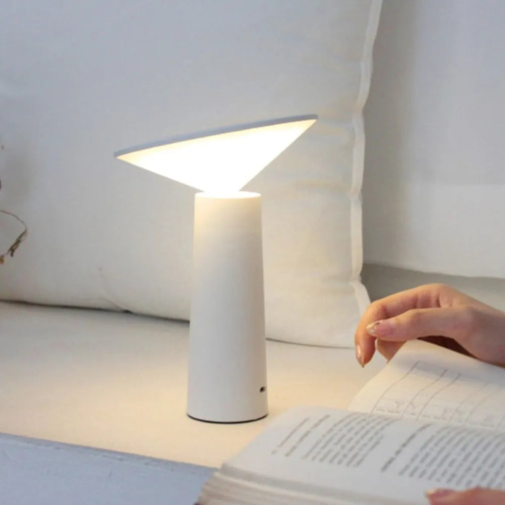 Black USB desk lamp with touch sensor and adjustable head on a wooden table