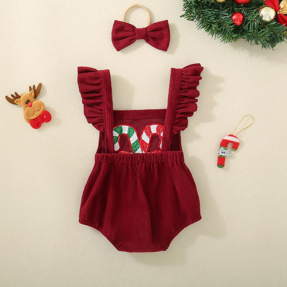Red sleeveless cotton triangle romper for babies and toddlers with embroidered wing detail, shown in 70cm to 100cm sizes