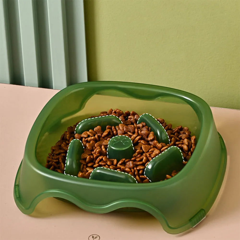 A blue plastic dog slow feeder bowl designed to prevent choking, shown alongside grey, green, and orange colour options.