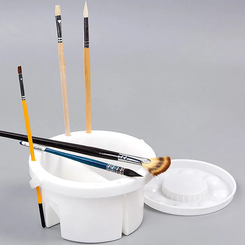 White plastic cylindrical brush holder with a side clip for painting.