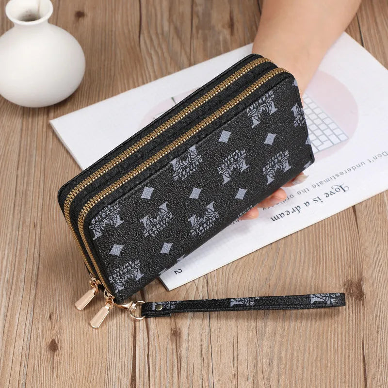 Retro style long wallet clutch in PU leather with a print design, shown in black colour.
