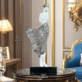 48cm tall sculptured character ornament in natural resin with rose gold finish on wooden surface