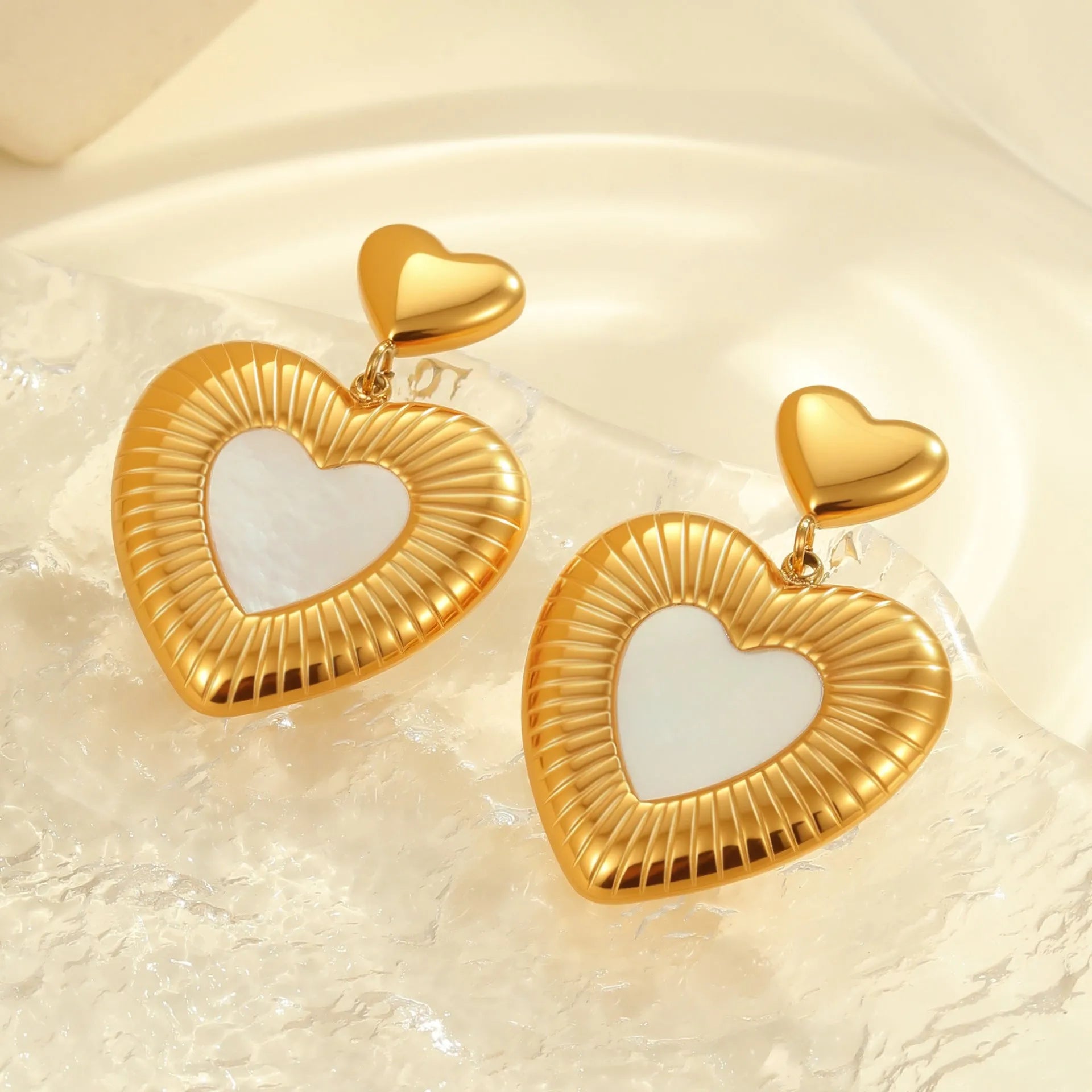 A pair of gold heart-shaped white fritillary earrings for women, made from stainless steel with 18K electroplating.