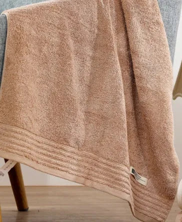 Cotton towel set in brown showing three sizes: large bath sheet, standard bath towel and small hand towel