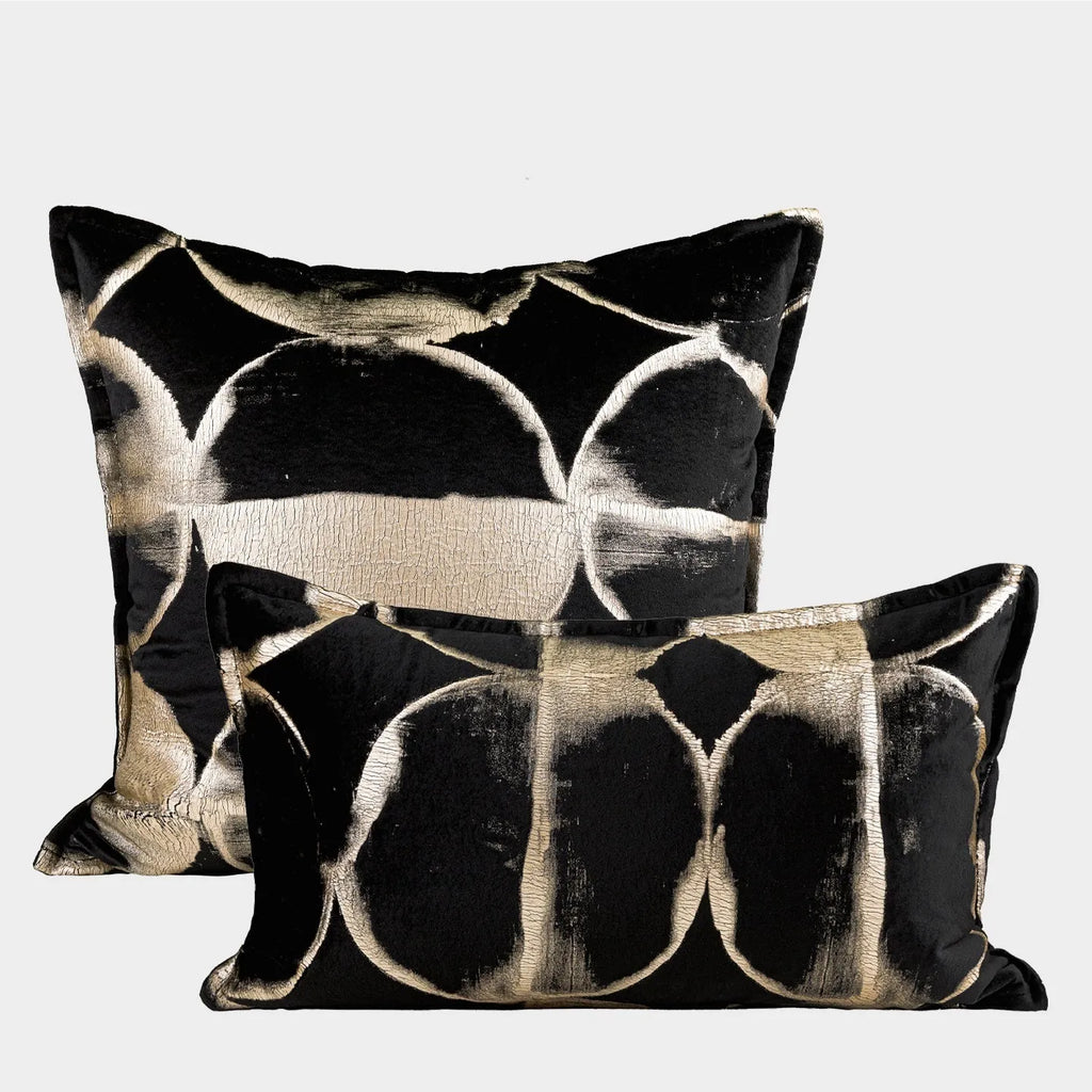 Black gold abstract pattern cushion with removable cover in three size options on furniture