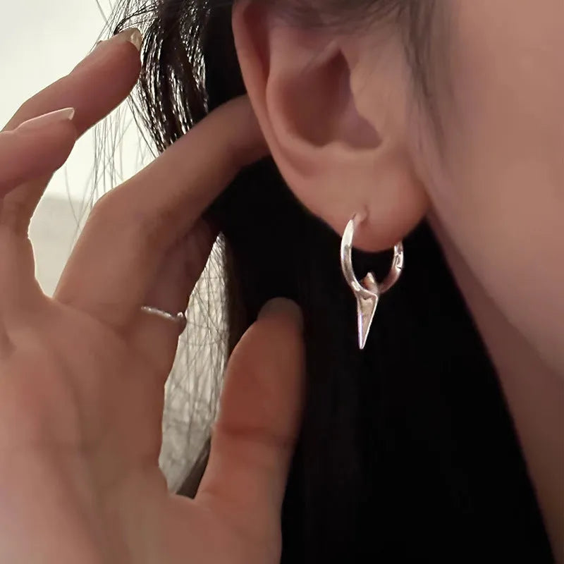 Geometric star ear clips with white gold electroplating on copper, showing secure clip mechanism and detailed star shape