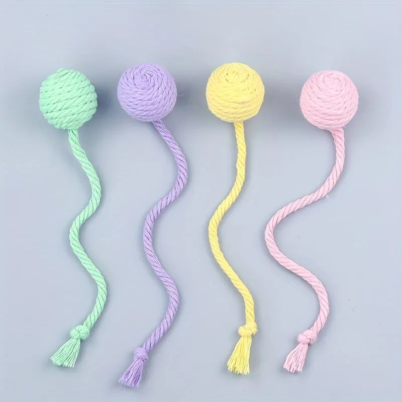 Colourful cat toy ball with attached rope and internal bell mechanism in green, pink, purple, or yellow options