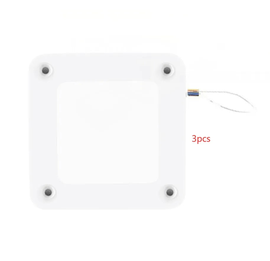 White automatic door closer tension box with adhesive backing and transparent hook for punch-free installation.