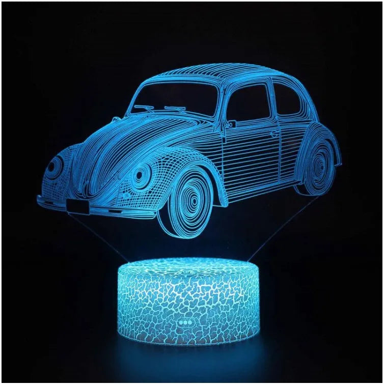 Small modern table lamp with colourful LED light and remote control on a desk.