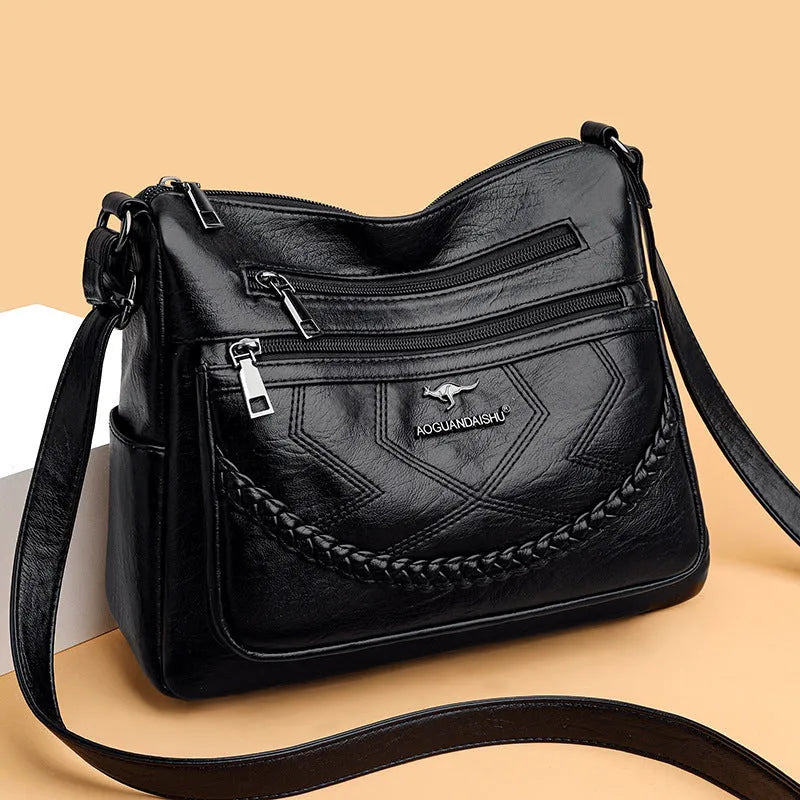Black soft PU leather shoulder bag with crossbody strap, showing 30cm width and zippered internal organiser