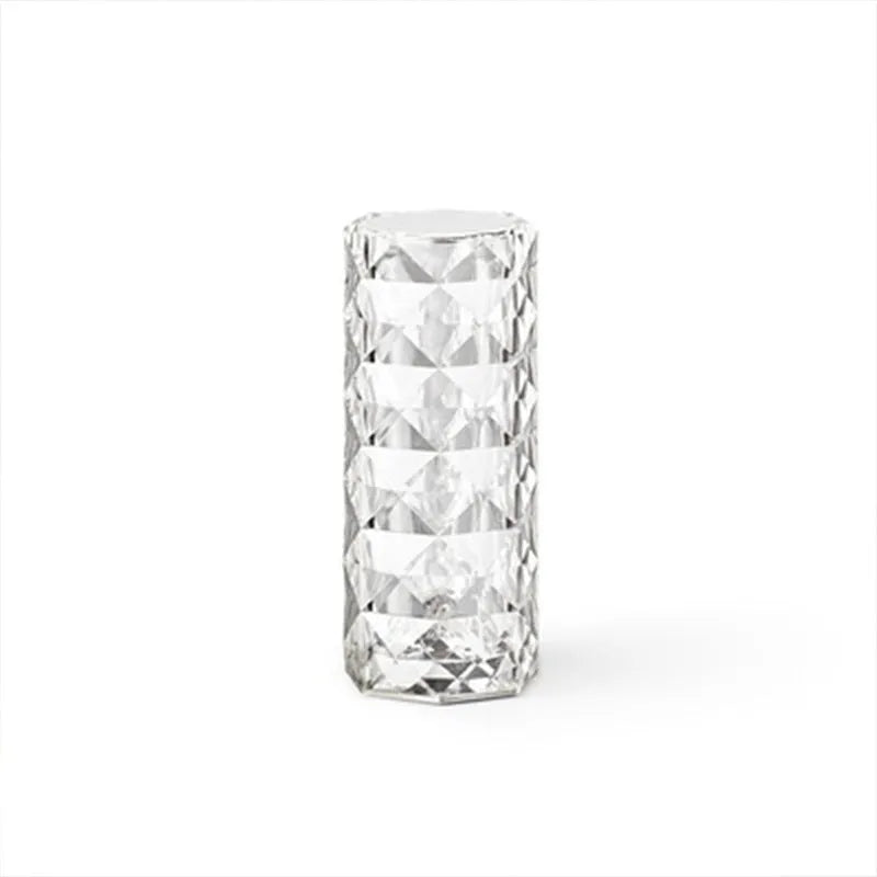 Clear acrylic rose-shaped LED table lamp with touch controls on a wooden surface.