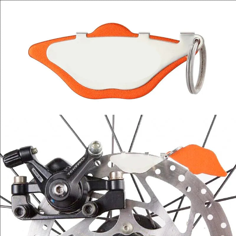 Mountain bike disc brake linings in black and orange colour options with metal construction and adjustment flap