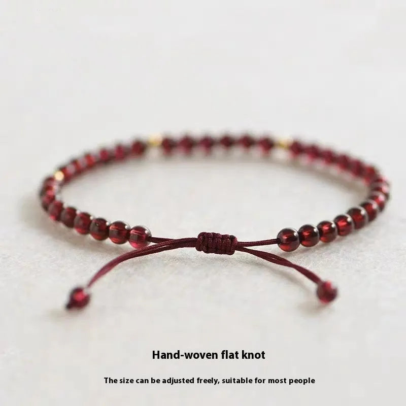 Hand-woven garnet red rope bracelet with flexible wire construction and national tide design elements