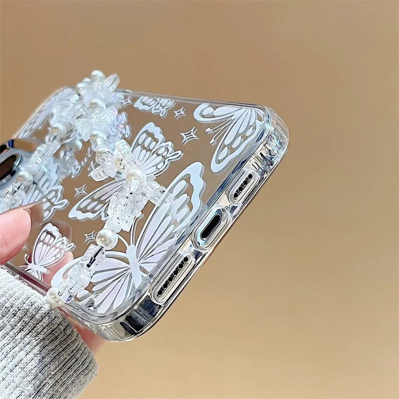 Transparent three-in-one mirror phone case for iPhone with detachable bracelet, showing bow decoration.