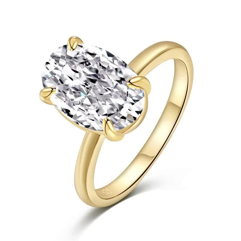 Oval women's ring in 9 silver with four-claw setting holding a 6x9mm gemstone, shown in gold and silver finishes.