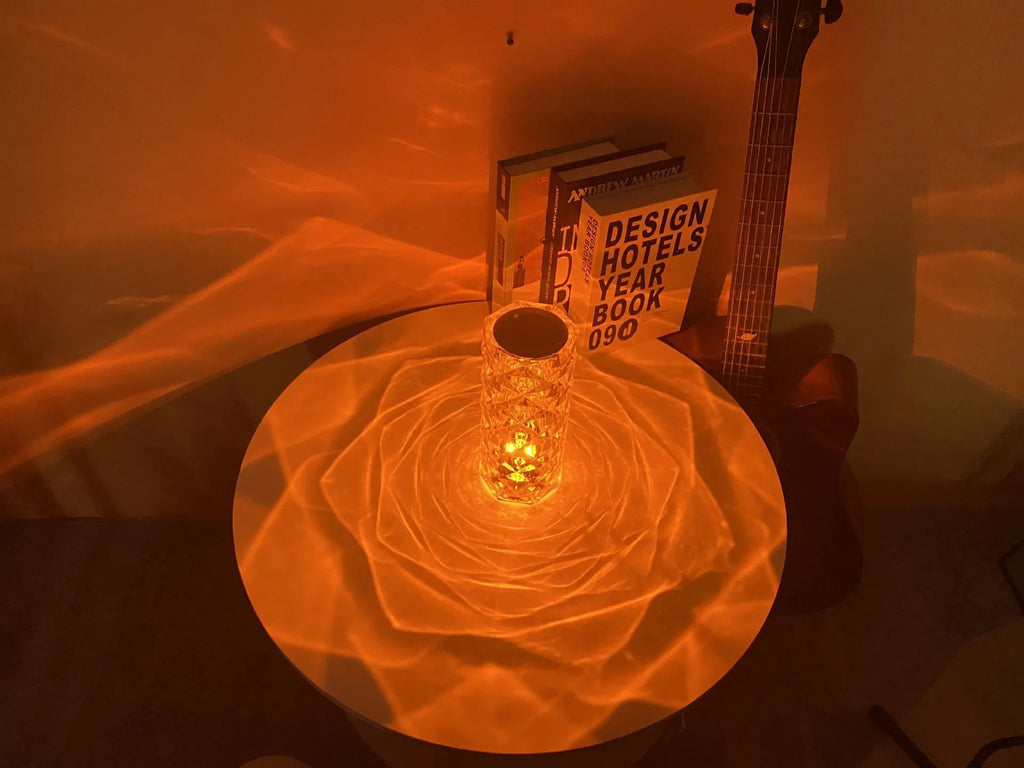 Clear acrylic rose-shaped LED table lamp with touch controls on a wooden surface.