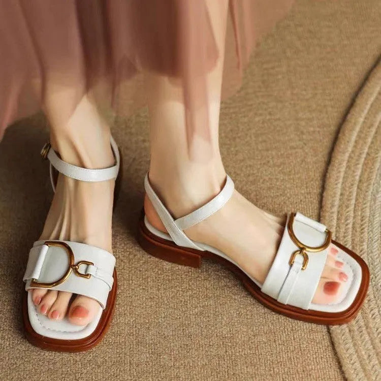 Women's black thick-soled casual sandals with a round toe and press-stud fastening.