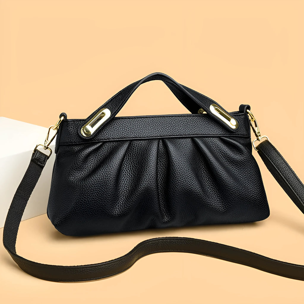 Leather niche pleated shoulder crossbody bag in black with horizontal square shape, multiple interior pockets and soft composite leather.
