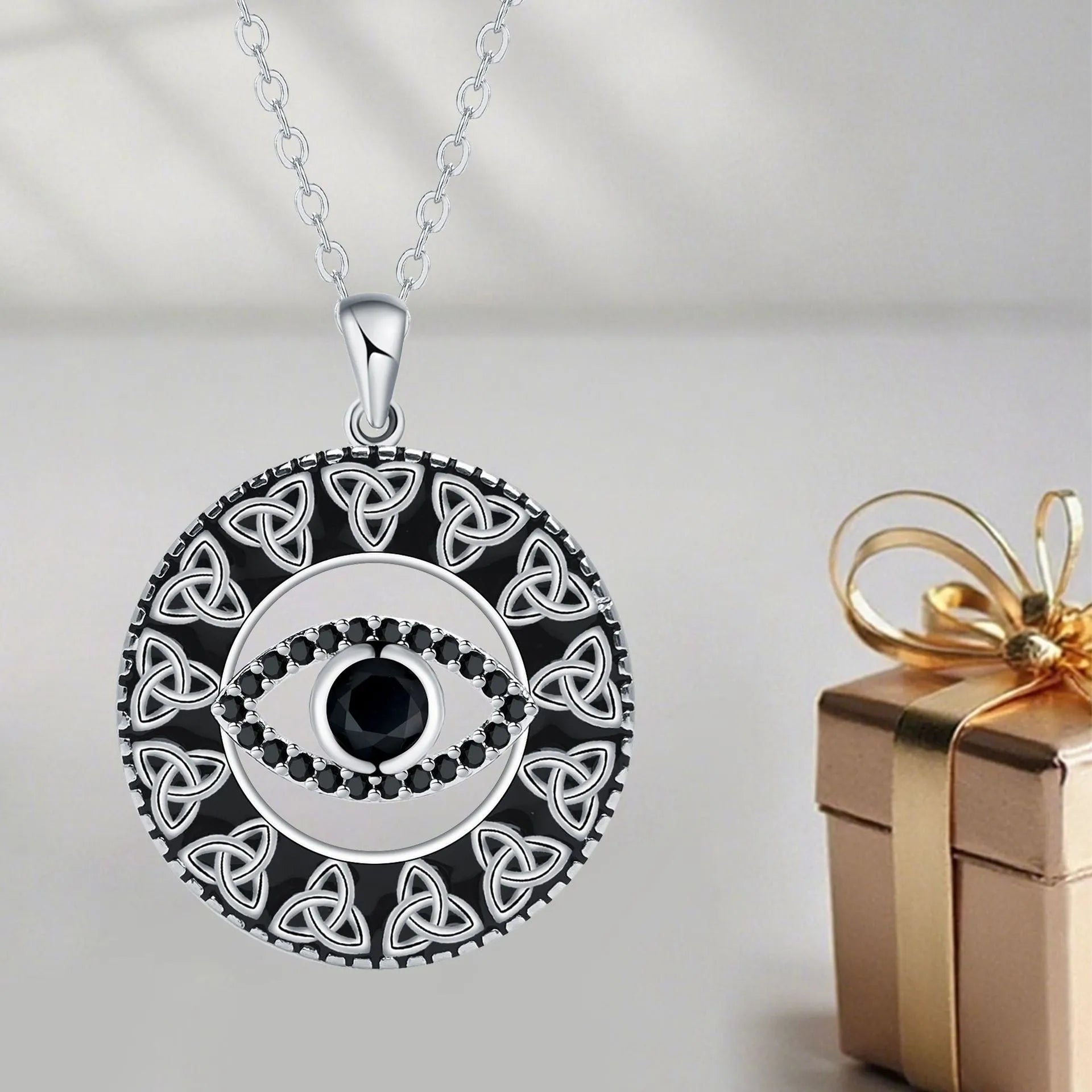 Copper devil's eye pendant necklace on a cross chain for women.