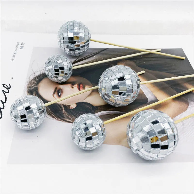 Glass disco ball cake decoration on wooden stick in silver reflective finish