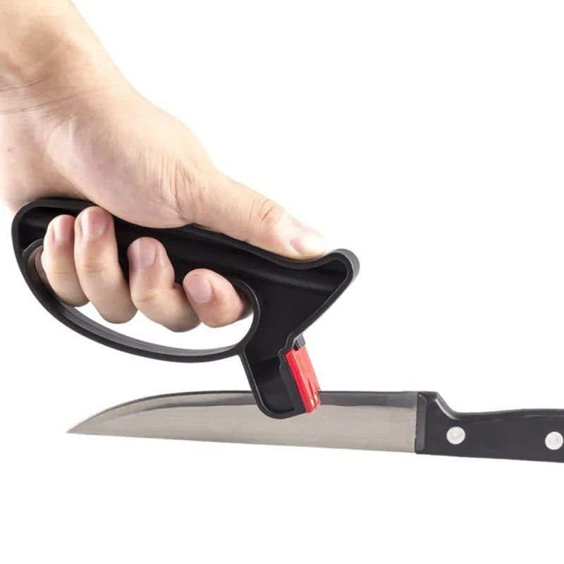 Black handheld tungsten steel knife and scissor sharpener on a kitchen counter