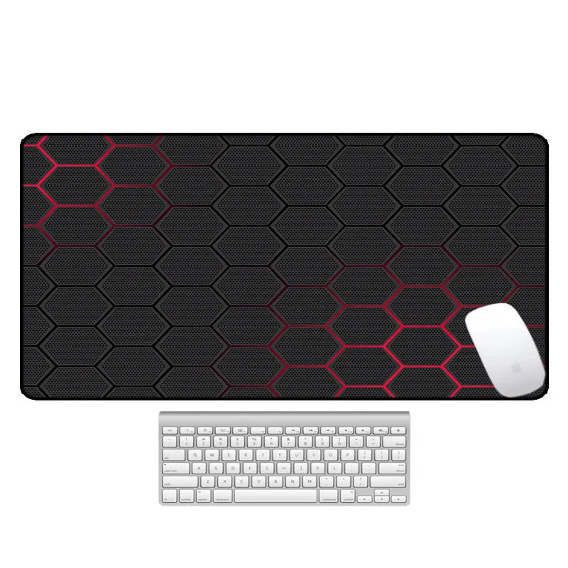 Large rectangular mouse pad with printed pattern lying flat on a wooden desk.