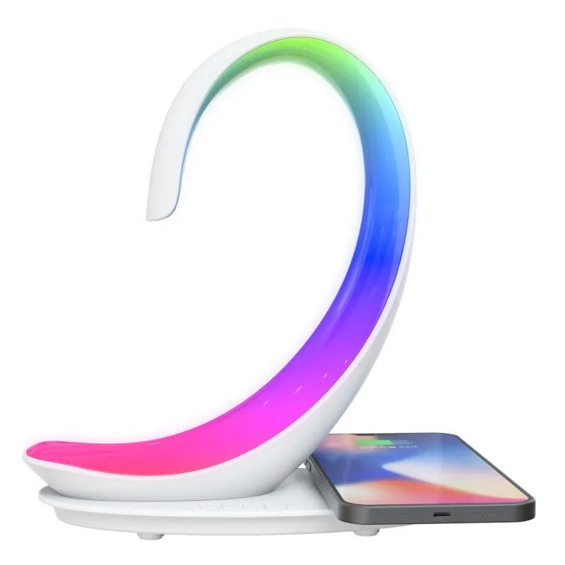 White swan shaped desktop device with colourful lighting, wireless charging pad, and Bluetooth speaker functions