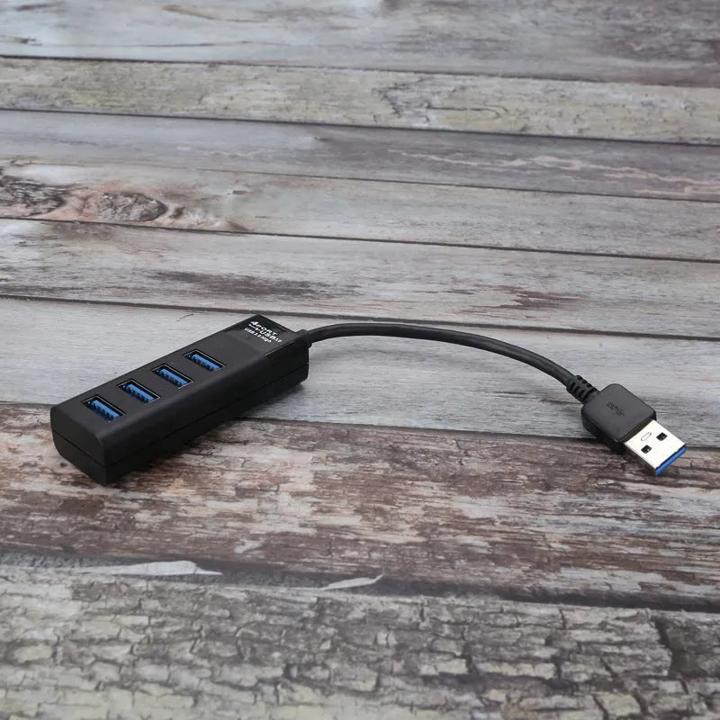 Black USB 3.0 hub with four ports, LED lights, and a 30cm connection cable