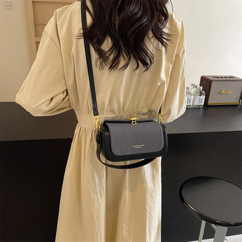 Women's PU leather messenger bag in horizontal square shape with contrast stitching and lock fastening