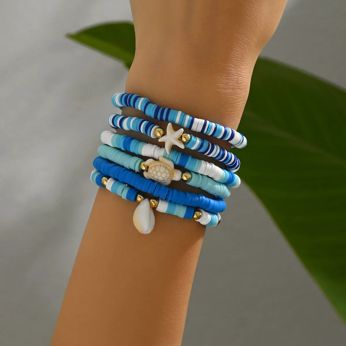 Six handmade polymer clay bracelets with geometric shapes and shell decorations in bohemian blue S3162 colour
