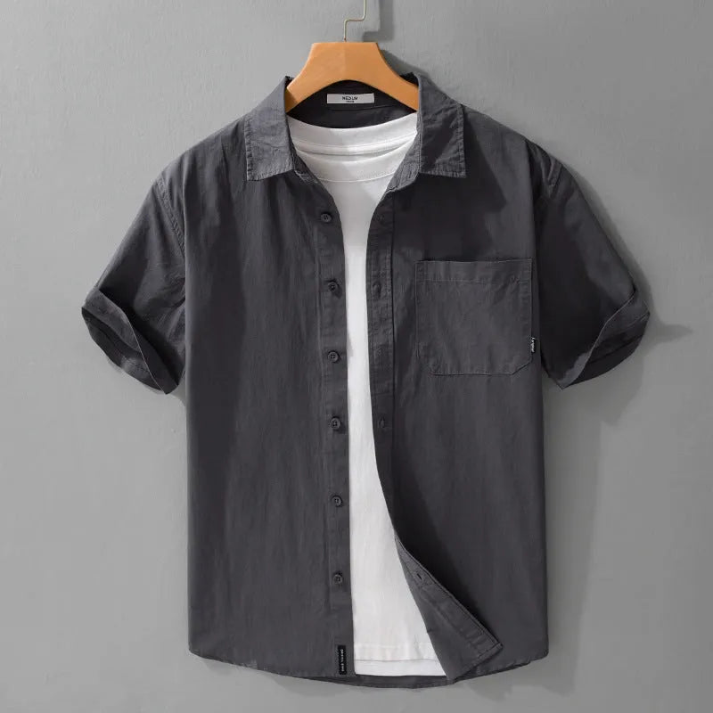 Men's light blue loose-fit short sleeve cotton shirt on a hanger.
