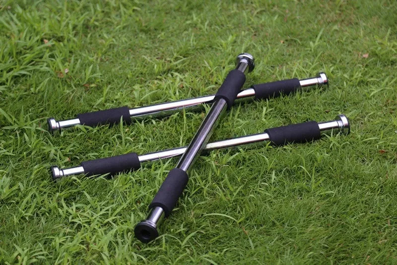 Steel adjustable pull-up bar extended across a door frame for home fitness training