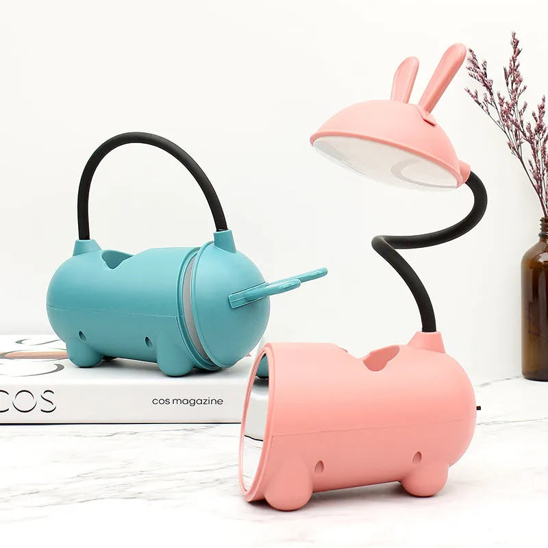 Green cartoon desktop lamp with pen container, USB cable, and modern simple design on wooden desk