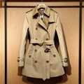 Khaki women's trench coat with double-breasted button front and distinctive flight sleeves