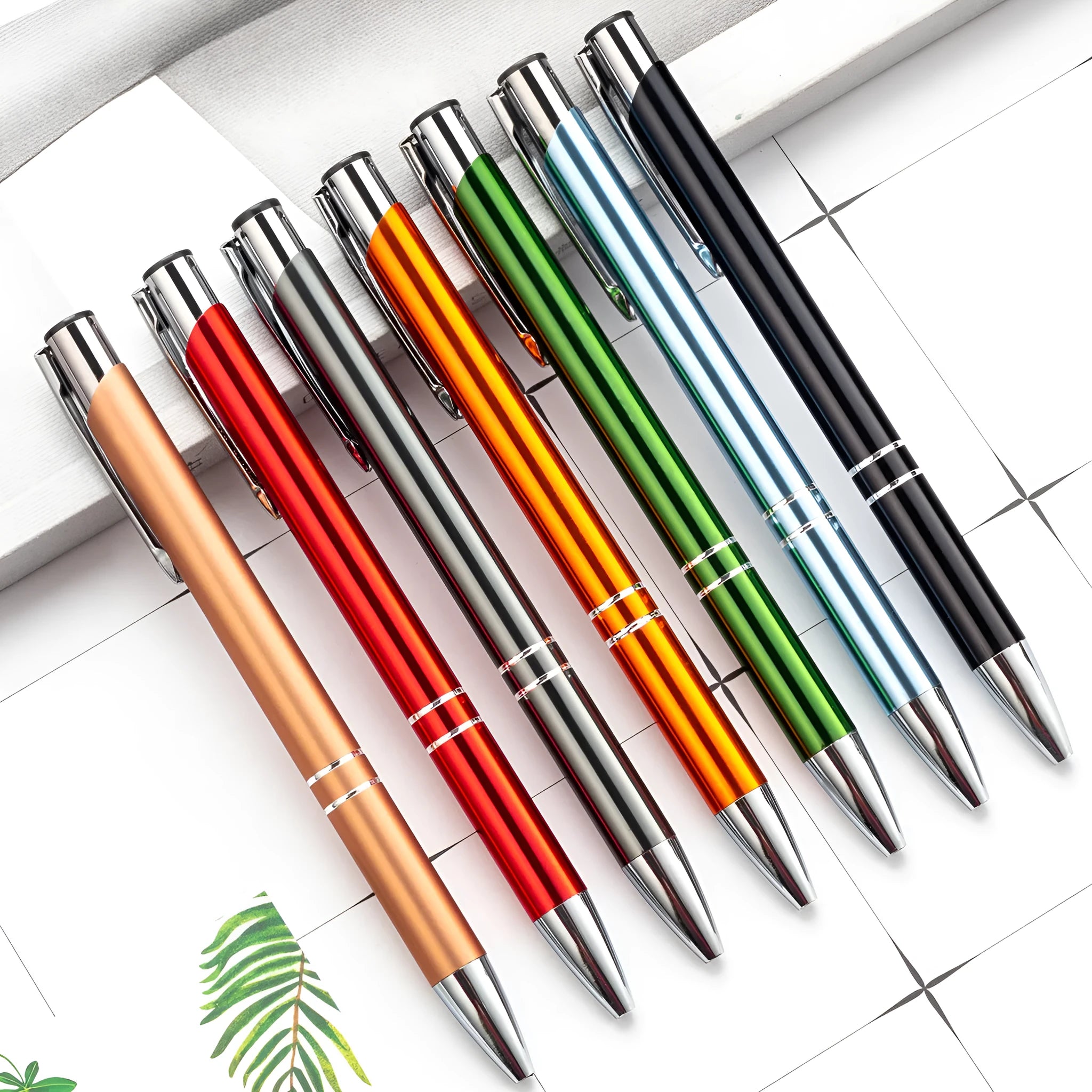Metal ballpoint pen with push-action mechanism in various colours including black, blue, and champagne gold