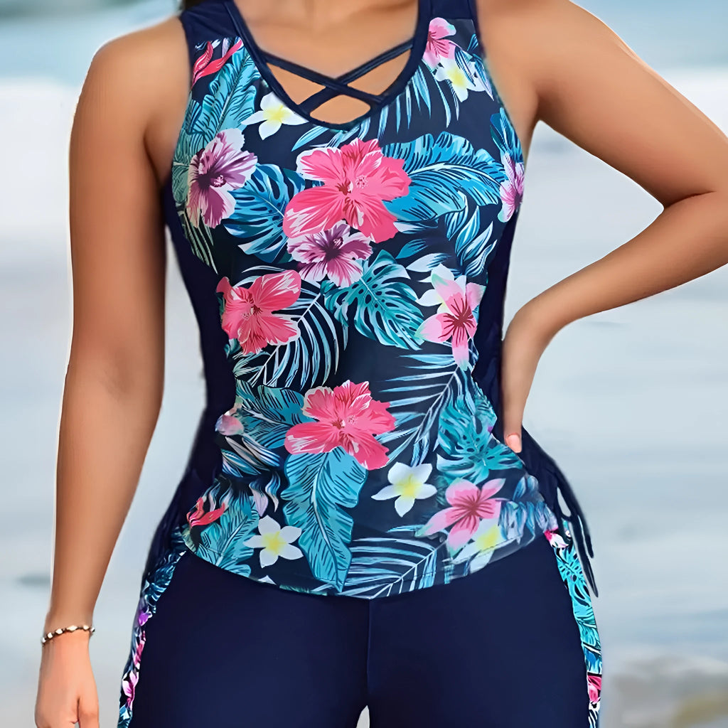 Plus-size woman modelling a high-waisted floral print bikini in blue, for swimming.