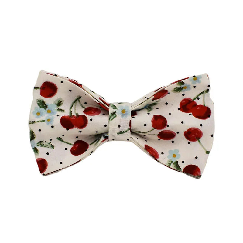 Red cherry printed cloth dog collar and leash set with matching vest, light gold buckle, and decorative bow strap.