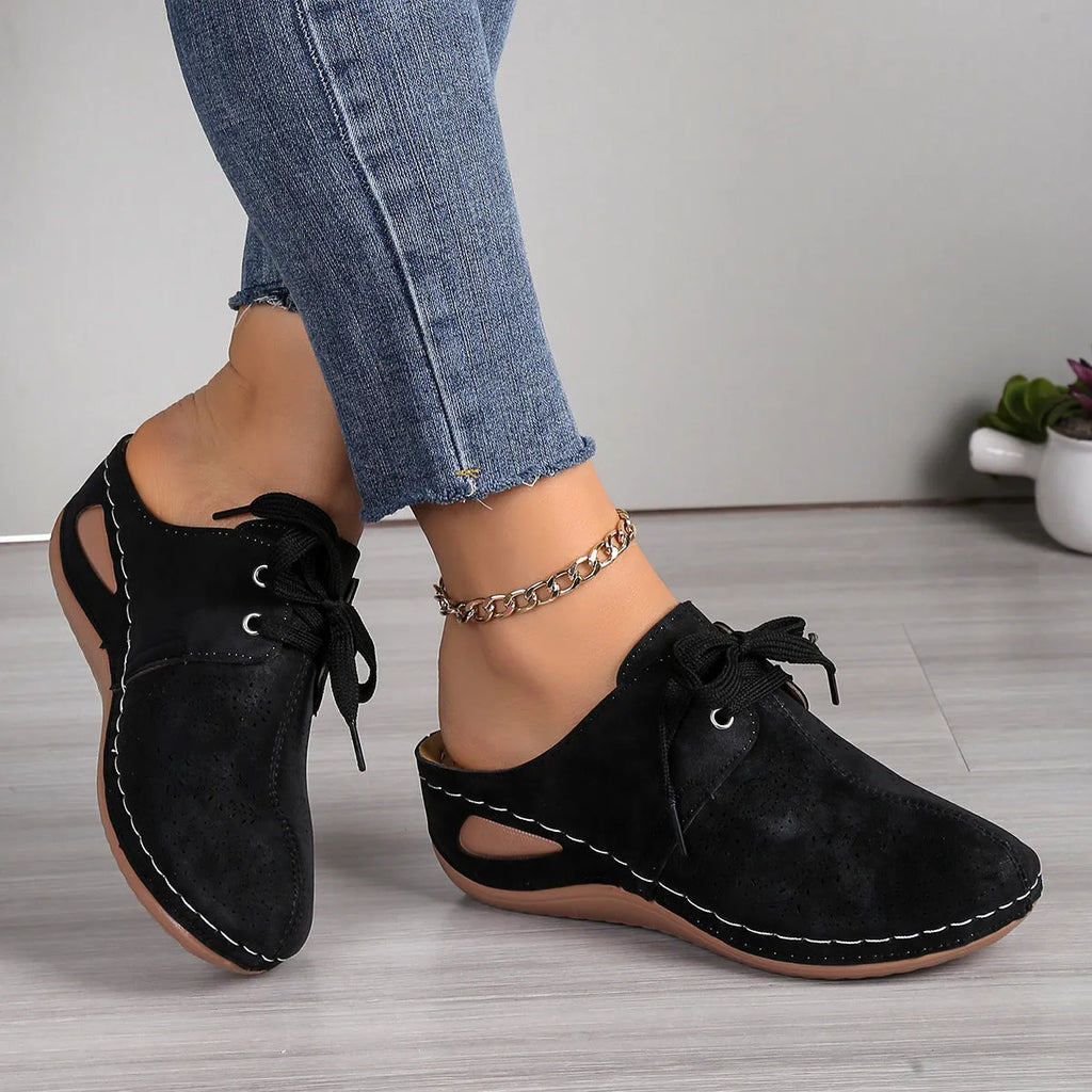 Women's Baotou lace-up slippers with hollow-out wedges in suede upper and rubber sole.