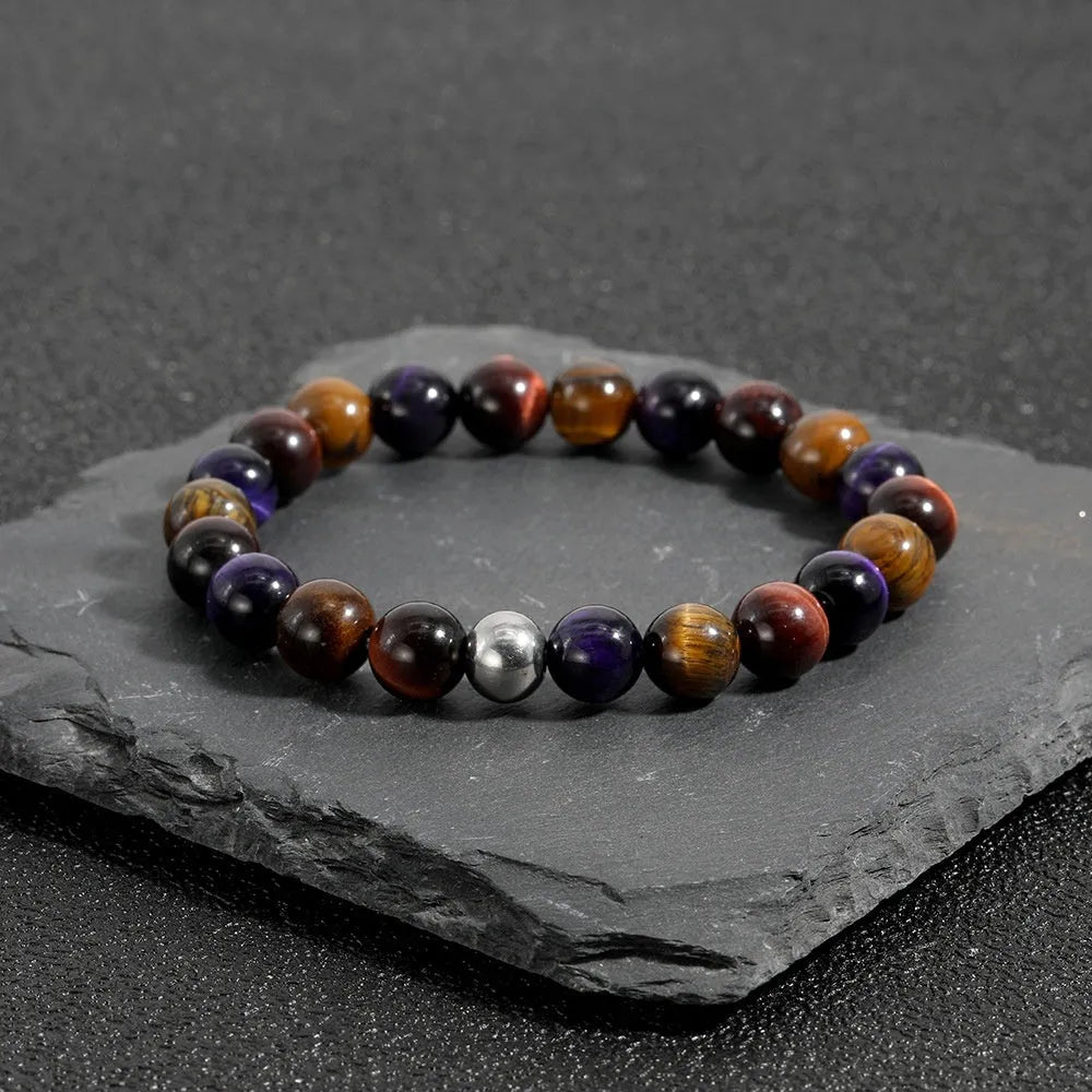 Handmade elastic bracelet with yellow, purple, and red natural tiger-eye stone beads in a geometry shape.