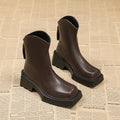 Black platform Martin boots for women with square toe, 6-8cm heel, and back zipper on a mid-calf shaft.